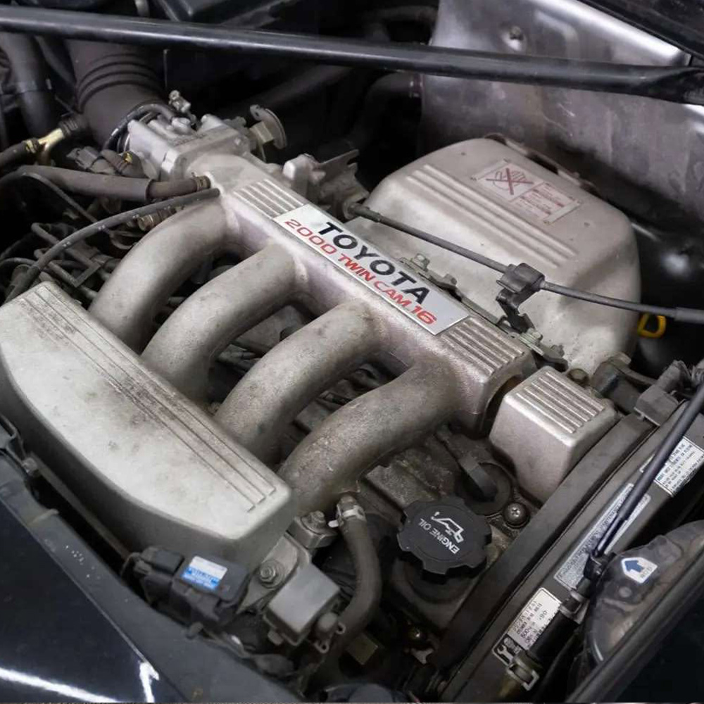 Dirty engine bay before professional car detailing